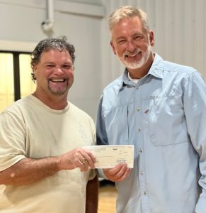 Tim King presenting to Jeff Summers of Reach Affordable Christmas